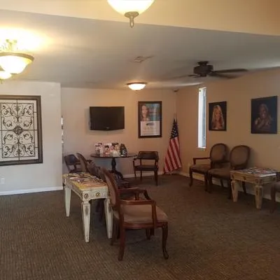 Spacious dental waiting room with comfortable seating, artwork on walls, and professional decor.